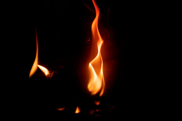 A tongue of flame bursting into flames. The budding of a fire. The flame looks like a burning candle. Copy space.