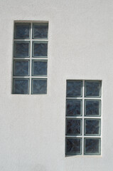 Two glass block windows looking outside on wall