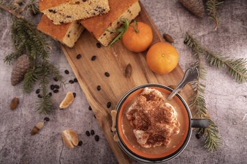 breakfast on table with waffles, sponge cake, coffe and mandarin.