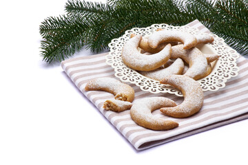 Traditional German or Austrian Vanillekipferl vanilla kipferl cookies on a plate isolated on white background