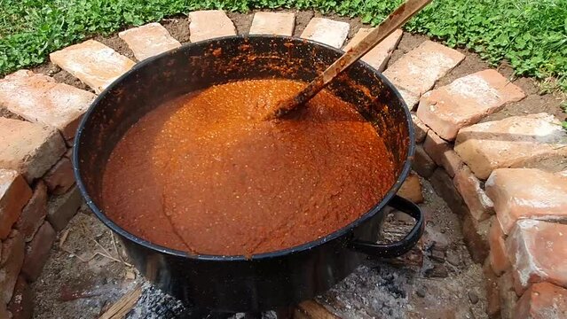 Cooking Red Peppers, Eggplant and Tomatoes. A Bulgarian Traditional Dish Called Liutenitsa.