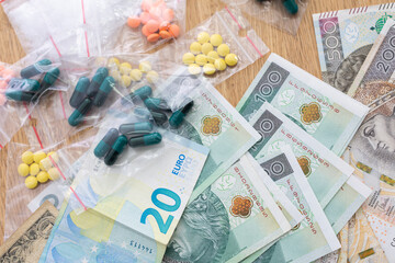 On the table lies currency in banknotes of various countries, and bagged drugs.