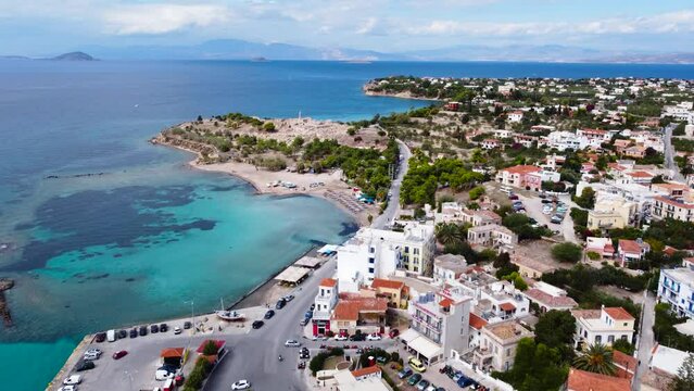 Aerial drone view to the beautiful beach of Moni island, next to the village Perdika on Aegina island with turquoise sea, Saronic Gulf, Greece