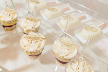 Candy bar and wedding cake. Table with sweets, buffet with cupcakes, candies, dessert.