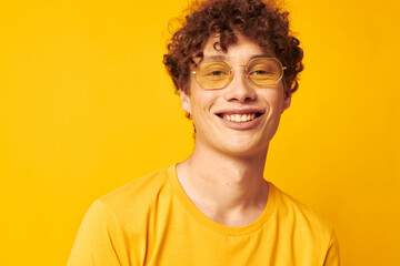 guy with red curly hair wearing stylish glasses yellow t-shirt posing isolated background unaltered