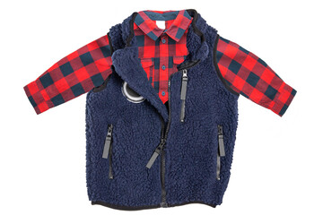 Fur vest. A blue fur vest with blue wool lining fabric and a red checkered shirt for the little boy isolated on a white background. Child spring and autumn fashion.