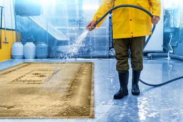 Carpet cleaning company worker soaking carpet for further cleaning with professional equipment