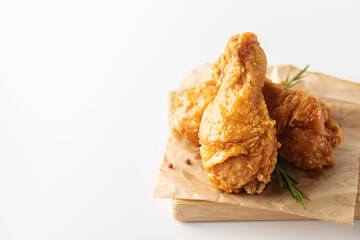 Fried crispy chicken legs on wood cutting board.