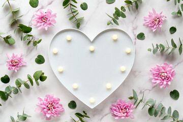 Heart shape lightbox. Winter flat lay with fragrant twigs and flowers. Wintertime eucalyptus, pink...