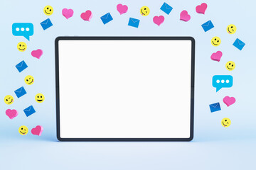 Close up of empty white mock up tablet screen with colorful social media icons on light background. Communication, follow and connection concept. 3D Rendering.