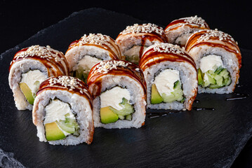 Set fresh delicious Japanese sushi on dark background