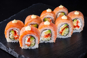 Set fresh delicious Japanese sushi on dark background