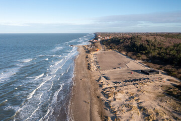 Tisvildeleje, Denmark - January 21, 2022: Aerial drone view of the coastline with the public parking lot at the beach.