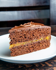 Chocolate Austrian dessert Sacher with apricot jam. One slice of traditional Sacher cake served on...