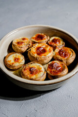 Stuffed mushroom caps with cheese and other stuffing, stuffed mushrooms. Georgian cuisine concept, traditional dish.