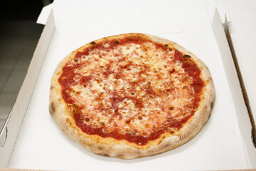 margherita pizza in cardboard