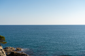 Seascape with calm waves and clear blue sky, spanish coast of costa brava