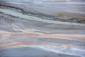 Muddy waters in a decantation pond. Toxic residuals from a copper mine decating in a settling basin