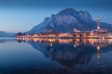 View of Lecco, Lombardy, reflecting on Como lake at blue hour, Italy