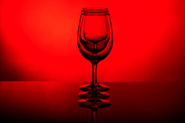 glass goblets on a red background, a composition of goblets