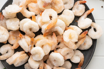 Thawed peeled shrimp, seafood, delicacy. on a white background, in a dish. beautiful product presentation