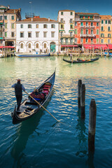 Goldoliere and gondola in Venice canals, Italy