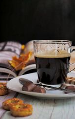 Cup of coffe with chocolate, sweets and book