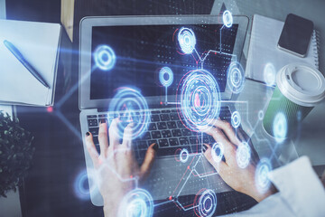 Double exposure of woman hands working on computer and data theme hologram drawing. Tech concept.