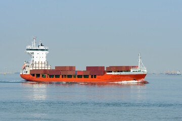 Feeder container cargo ship underway on a bright sunny day 
