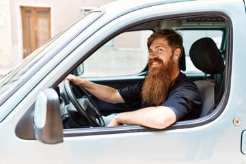 Young irish man smiling happy driving car at the city.