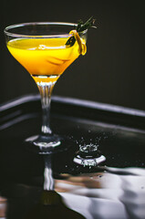 Orange fresh juice on a dark background.