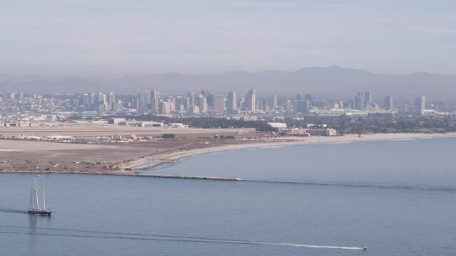 San Diego city skyline, cityscape of downtown with highrise skyscrapers, California coast, USA. View of Coronado island from above, Point Loma vista viewpoint. Frigate sail-powered ship, windjammer.