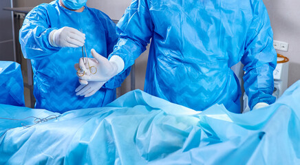 Medical team of surgeons in hospital doing minimal invasive surgical interventions.