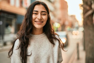 Young middle east girl smiling happy standing at the city.