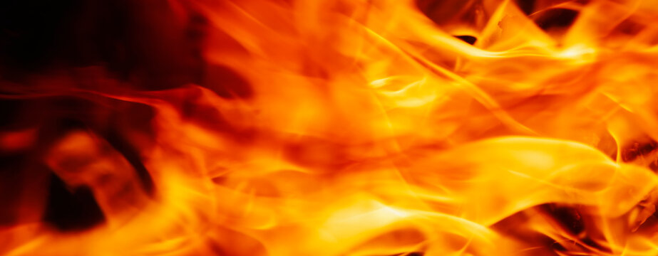 Abstract image of fire flames on dark background. Close up. Horizontal image.