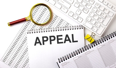 APPEAL text written on notebook on the chart with keyboard and planning