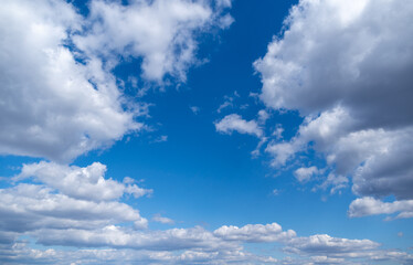 Fototapeta na wymiar Stock color photography of clear sunny blue sky with beautiful delicate soft fluffy white clouds moving along sky. Natural video background
