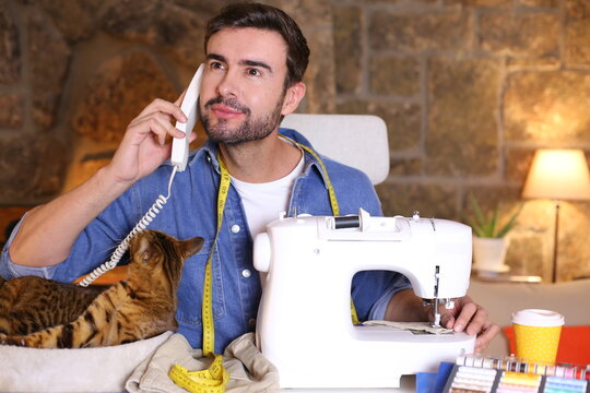 Male fashion designer making a phone call