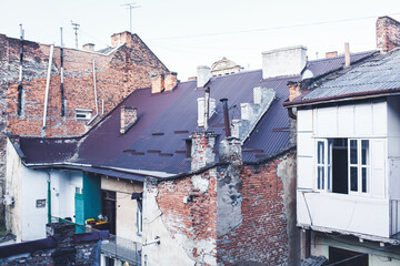 Old worn-out brick house. Brick wall is crumbling. Concept of poverty