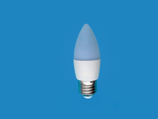 LED light bulb isolated on a blue background.  Energy saving light bulb.