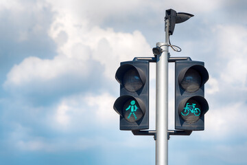 Green bicycle and pedestrian traffic lights. Green traffic light for bikes, gives cyclists...