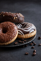 Chocolate donuts and coffee beans, sweet delicious baked dessert