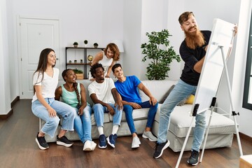 Group of young friends smiling happy playing drawing game at home. © Krakenimages.com