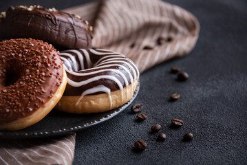 Chocolate donuts and coffee beans, sweet delicious baked dessert