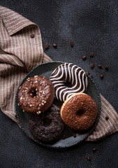 Chocolate donuts and coffee beans, sweet delicious baked dessert