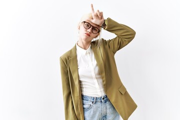 Beautiful caucasian business woman standing over isolated background making fun of people with...