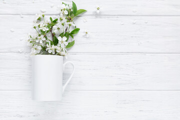 Spring mug mockup with blossom cherry, flat lay on wood background with copy space