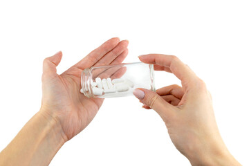 white pills in the hand on a white isolated background