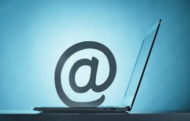 At symbol on top of open laptop. Email. Mailbox digital safety or fishing attack