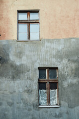 Old windows on a gray-brown wall / Torun, Poland